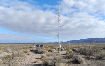 An instrument called an eddy covariance tower, which measures water transfer from land to atmosphere, sits in the desert.